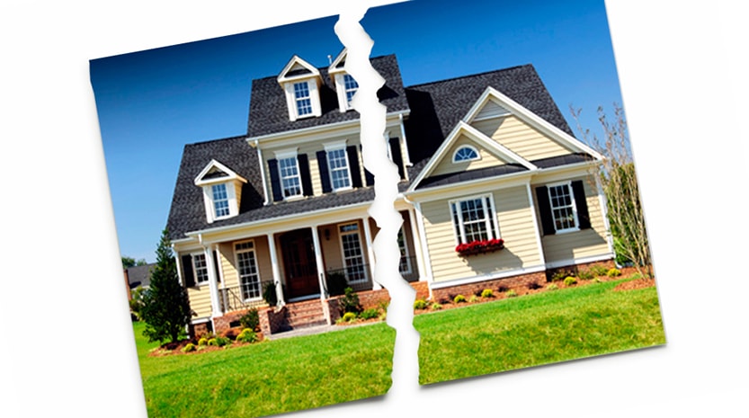 A photograph of a beautiful two story home with green grass and pretty landscaping on a sunny day is torn right down the middle and set on a white background.