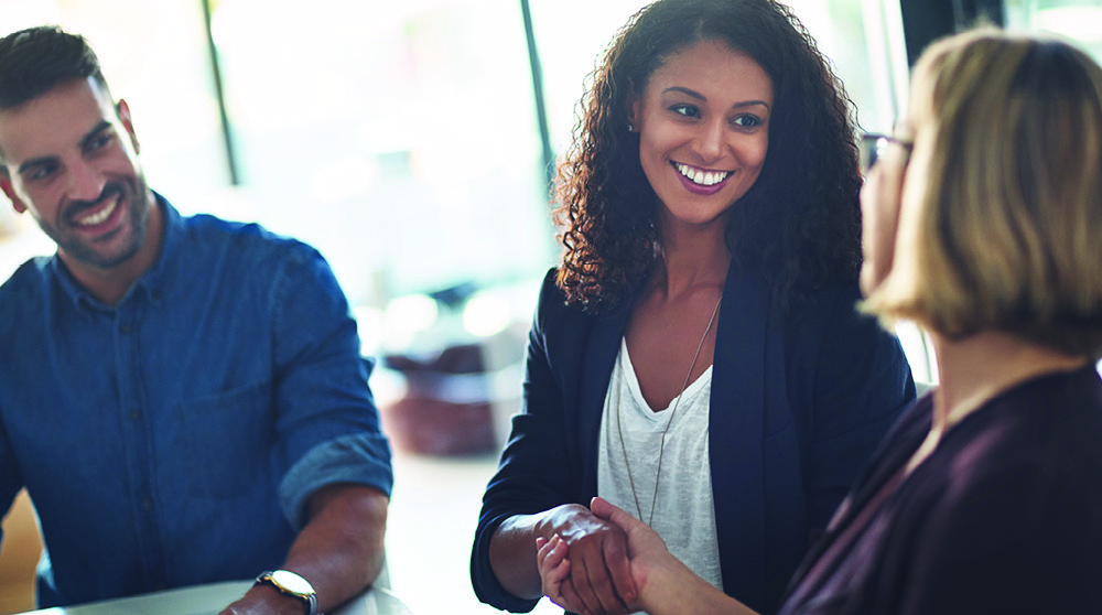 Woman shaking hands with employer